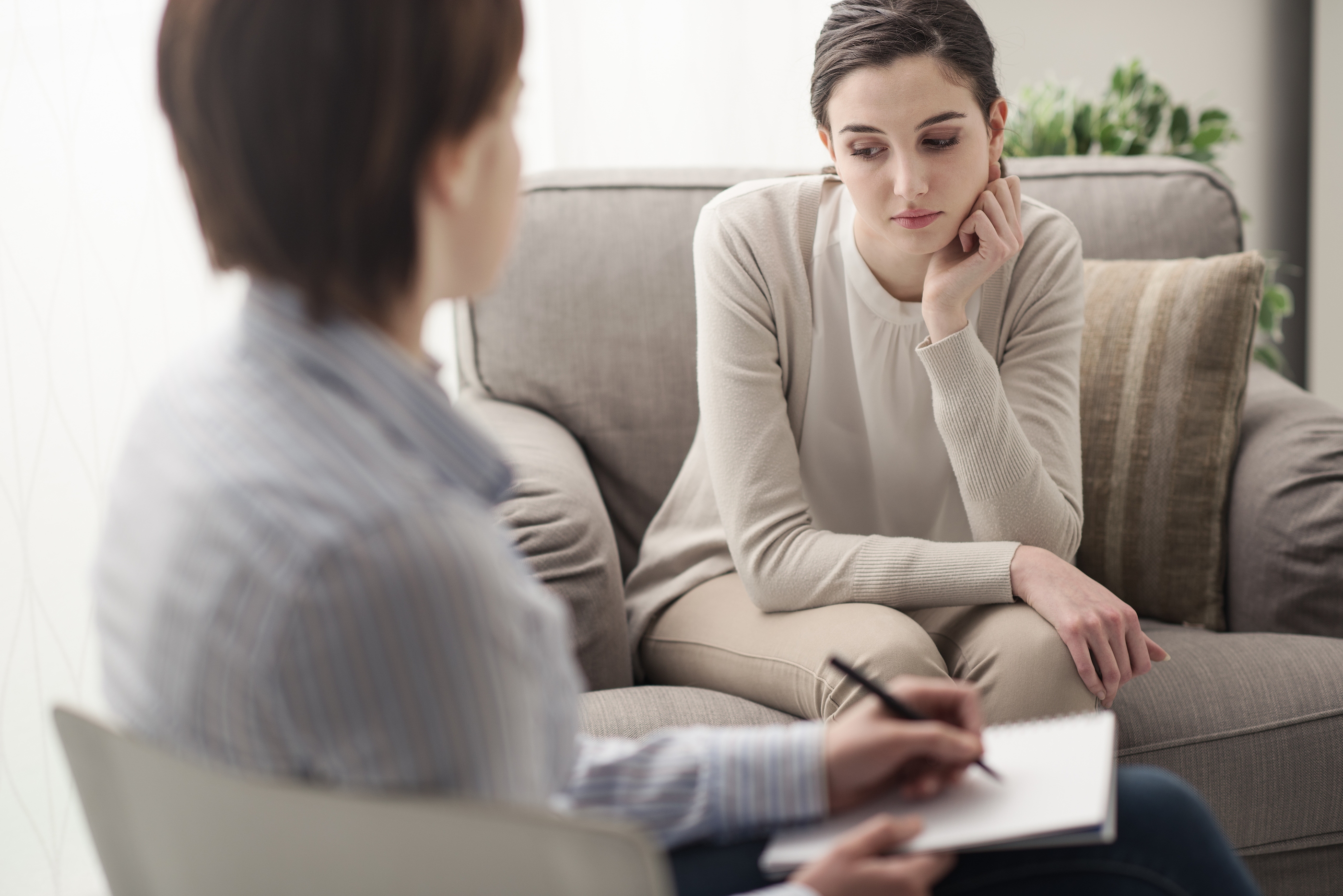 Young female patient talking with her therapist in the office mental health and psychotherapy concept