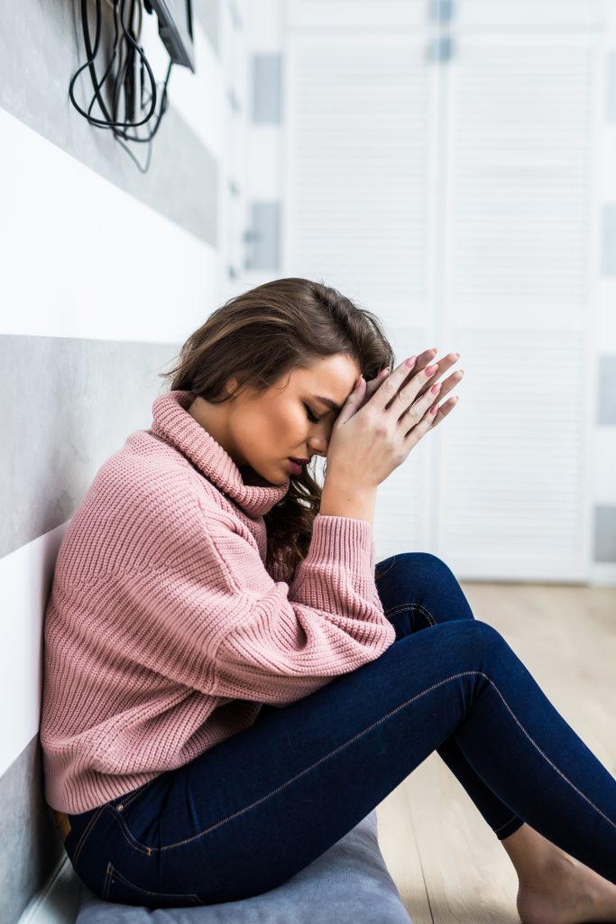 Young woman in depression. A woman sitting alone and depressed. The depression woman sit on the floor