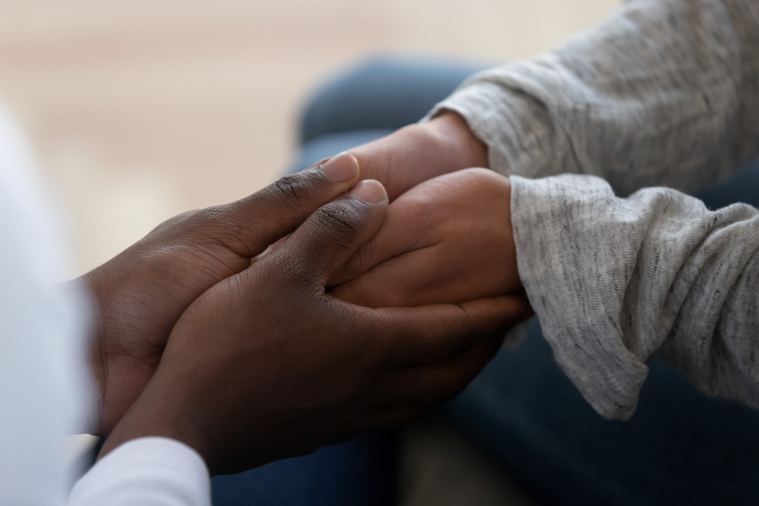 Mixed ethnicity family couple holding hands express support in marriage