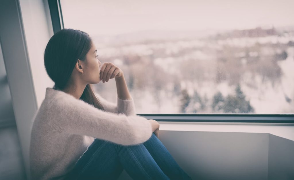 Woman in deep thought staring out the window