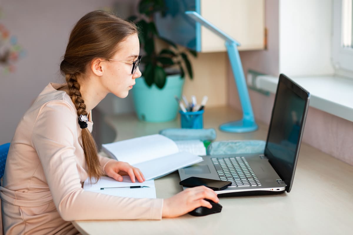 A teen struggles with her online classes while learning from home during the COVID-19 pandemic