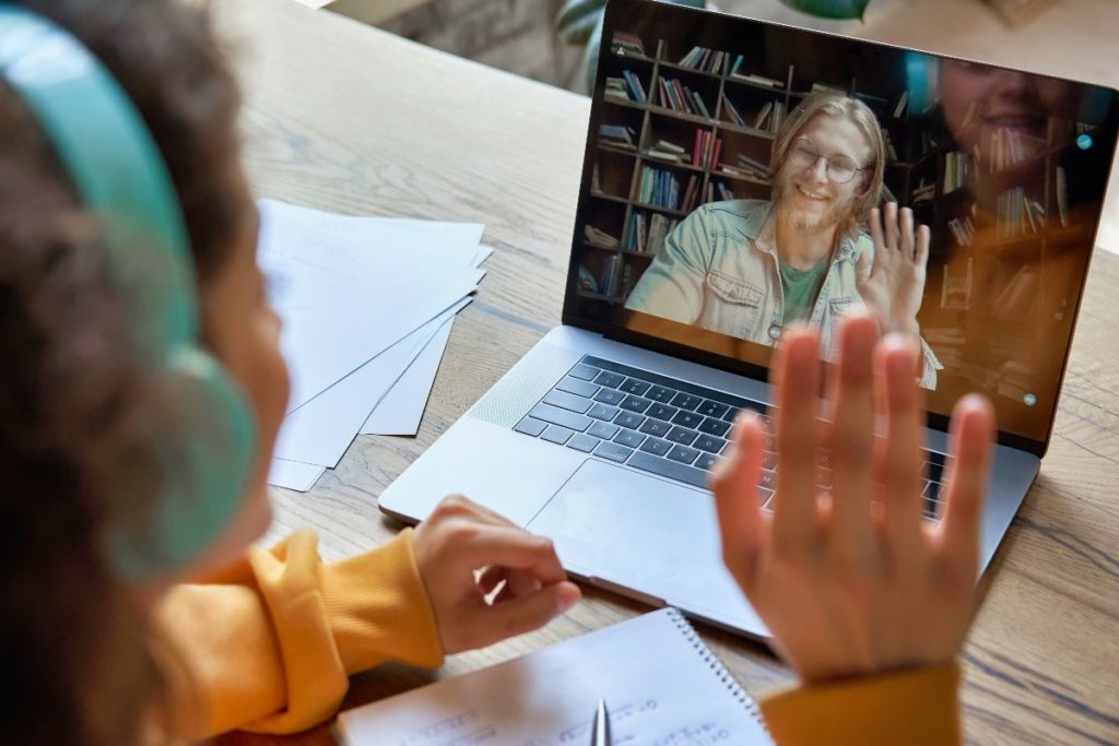 A high school student meets virtually with a counselor to discuss their mental health