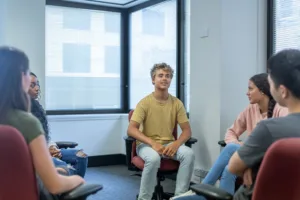 a-multiracial-group-of-high-school-students-in-group-therapy-session-seeking-counseling-at-school-stockpack-gettyimages