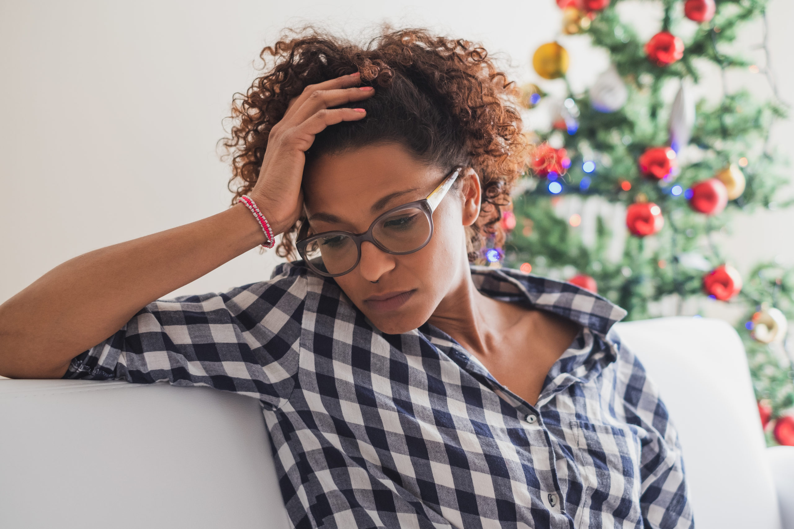 Pensive and lonely black woman during christmas celebration days