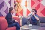 A young man with problems at a one-on-one meeting with a female therapist. Belgrade, Serbia