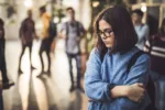 displeased-female-student-bullied-by-her-classmate-standing-alone-in-a-hallway-stockpack-gettyimages Displeased female student bullied by her classmate standing alone in a hallway.