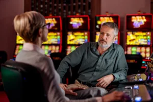 Two conversations talking in a casino one a professional the other a patient discussing transfer addictions