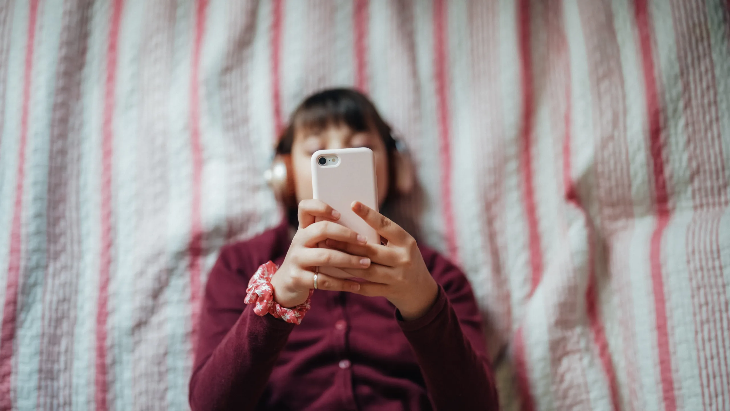 Girl in bed doom scrolling on her phone
