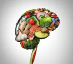 Healthy brain food to boost brainpower nutrition concept as a group of nutritious nuts fish vegetables and berries rich in omega-3 fatty acids for mind health as a composite image.