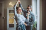 mature-couple-for-christmas-at-home-they-are-standing-in-front-of-window-and-dancing-stockpack-gettyimages Mature couple for Christmas at home. They are standing in front of window and dancing.