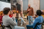 Sad young man sharing his experience and problems with depression to a members of a support group.