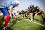 Semi pro football players line up for a play during a scrimmage with an opposing team. (with vignette)