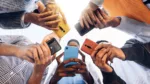 teens-in-circle-holding-smart-mobile-phones-multicultural-young-people-using-cellphones-outside-teenagers-addicted-to-new-technology-concept-stockpack-gettyimages Teens in circle holding smart mobile phones - Multicultural young people using cellphones outside - Teenagers addicted to new technology concept