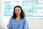 wearing-her-scrubs-the-female-young-adult-medical-student-looks-at-the-camera-and-smiles-broadly-stockpack-gettyimages Wearing her scrubs, the female young adult medical student looks at the camera and smiles broadly.